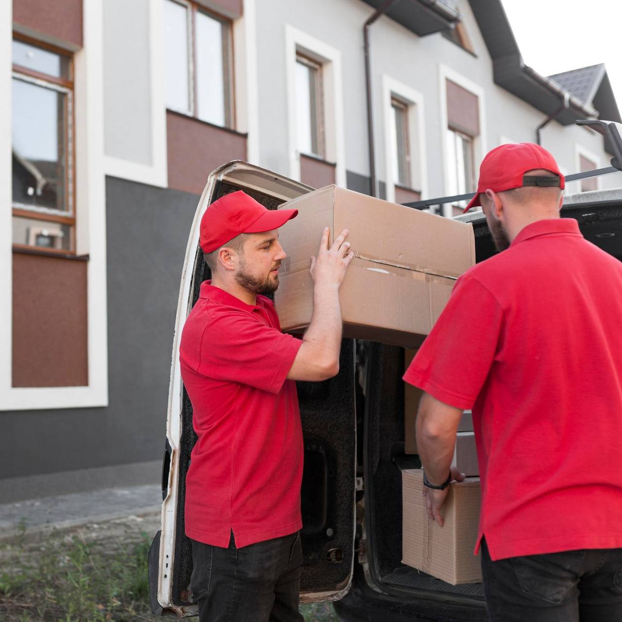 Movers carefully loading cartons into the moving van during a Surat house shifting